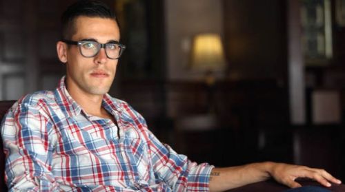 Ryan Holiday sitting in a chair in his home.