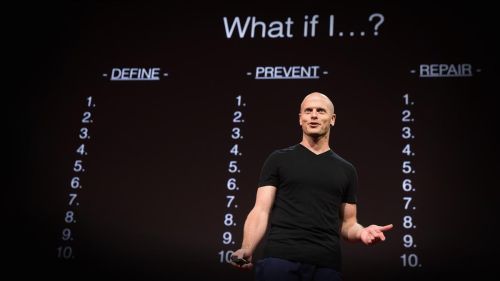 Tim Ferriss giving his Fear-Setting TED talk in front of a slide that has "What if I?" at the top and 3 columns below it: Define, Prevent, and Repair.