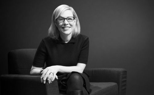 Debbie Millman sitting in a chair.