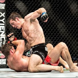 Tim Kennedy pummeling an opponent on the ground in MMA competition.