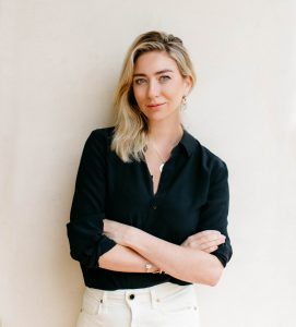 Whitney Wolfe Herd in front of a white wall.