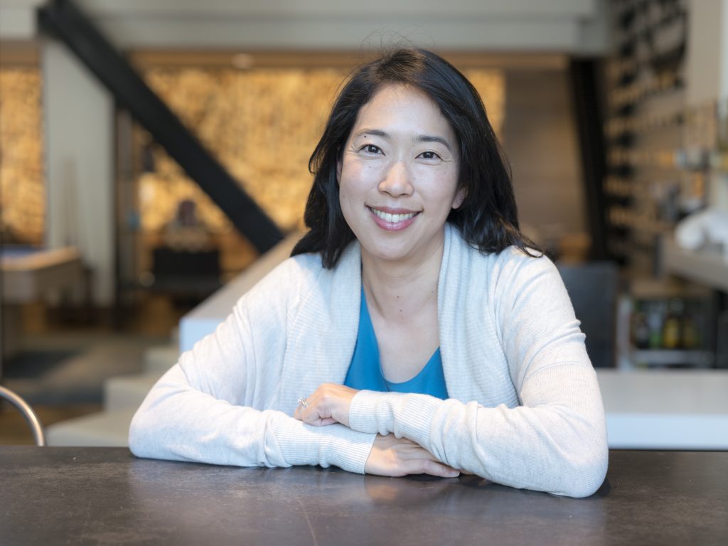 Ann Miura-Ko seated at a table.