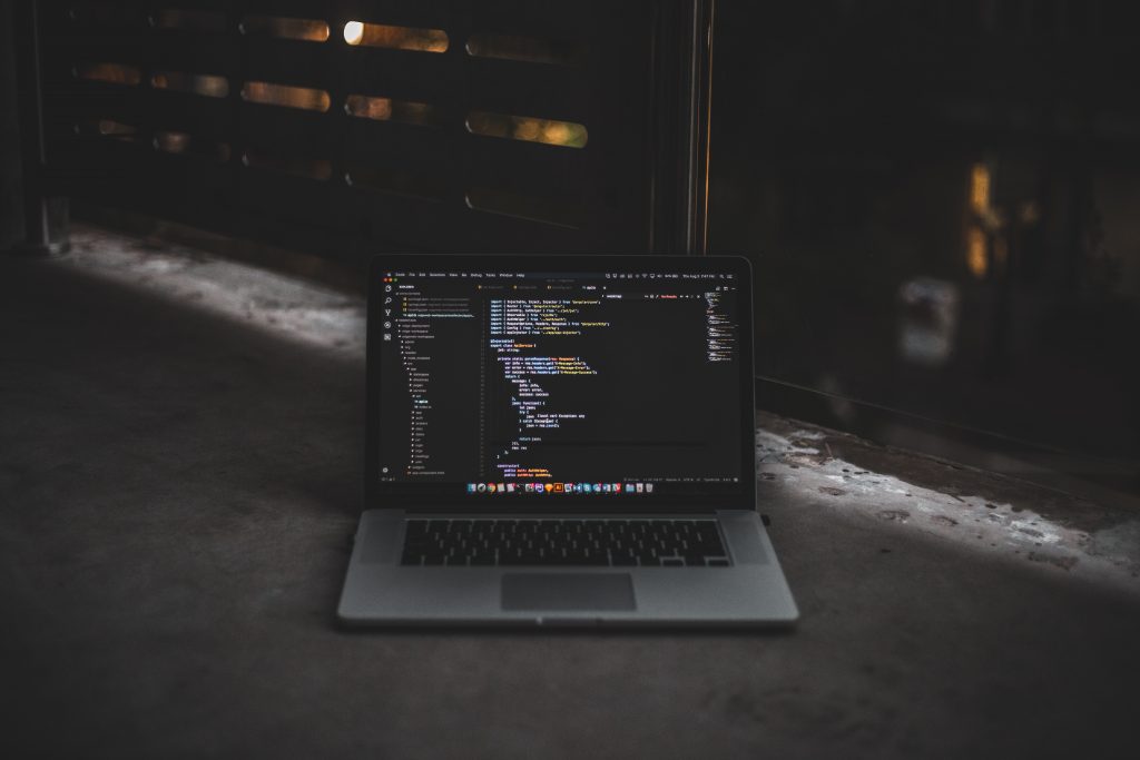 an open laptop with computer code on the screen.