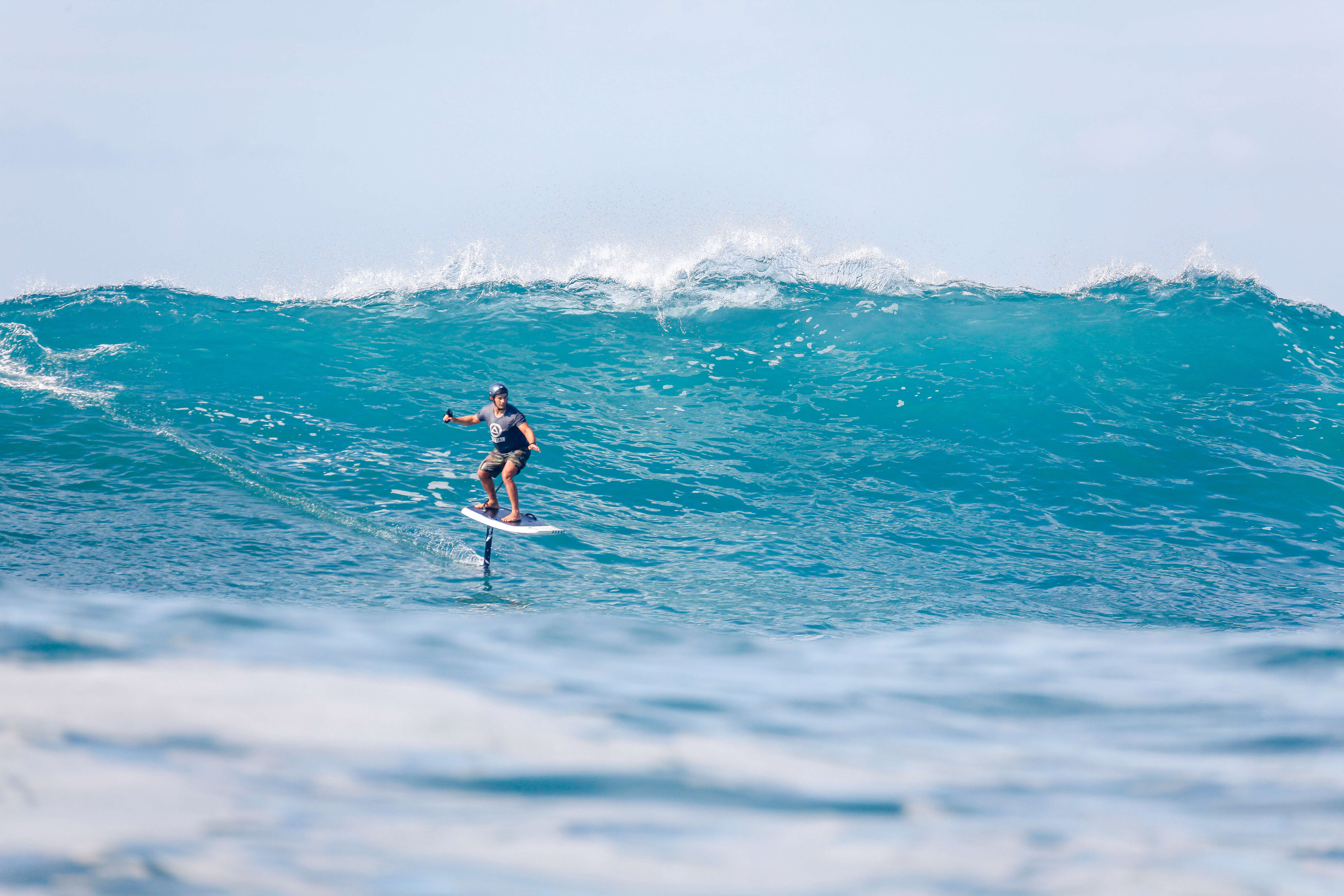 Josh Waitzkin foil surfing a wave.