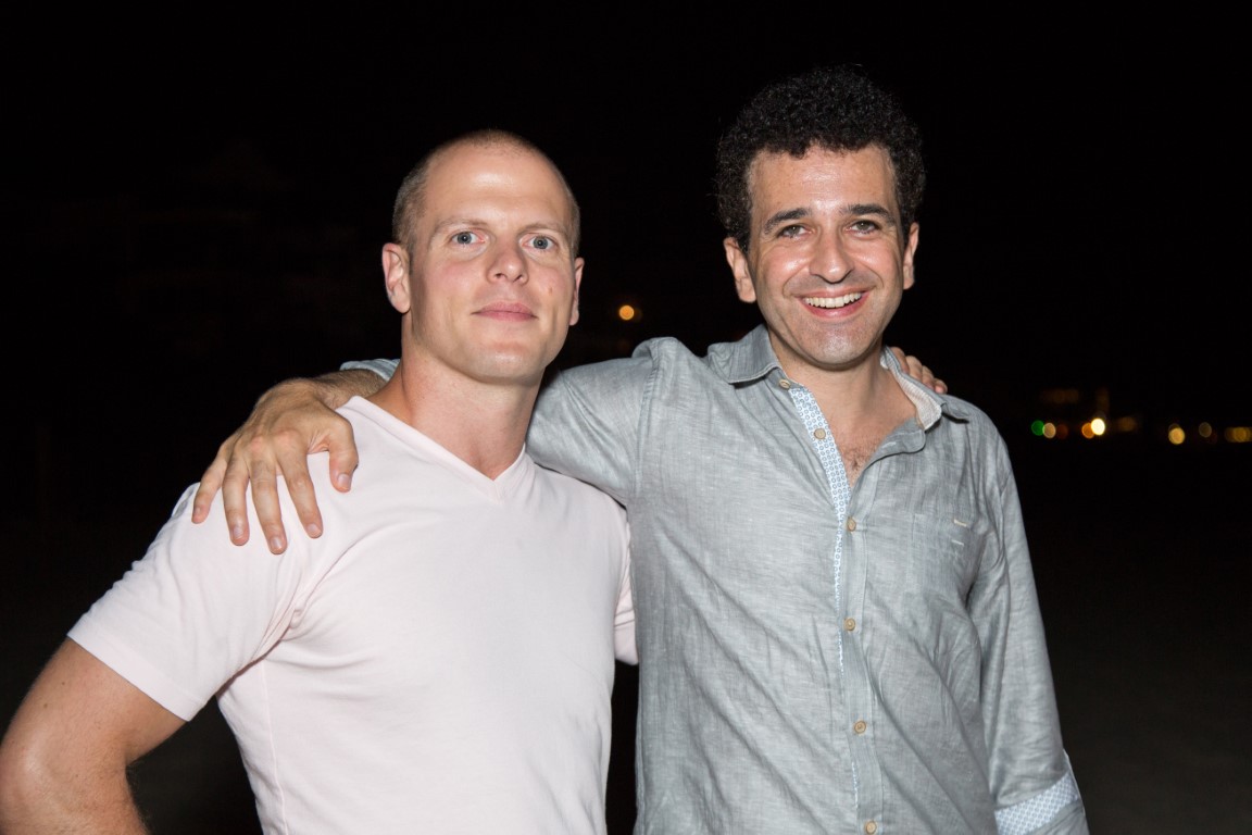 Tim Ferriss and Safi Bahcall standing outside at night.