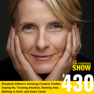 Elizabeth Gilbert with a soft smile and resting her face in her hands.