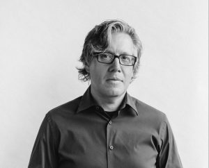Nick Kokonas in glasses and a dark button-down.