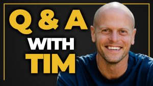 YouTube thumbnail of Tim Ferriss smiling with the words "Q&A with Tim" in gold and white to the right of his head.